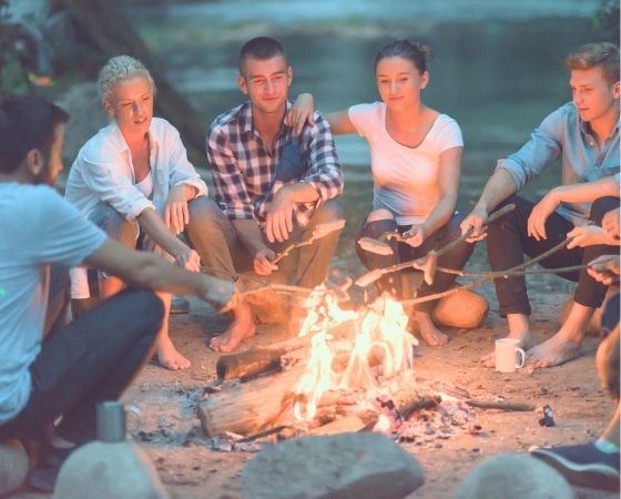 People at a beach campfire